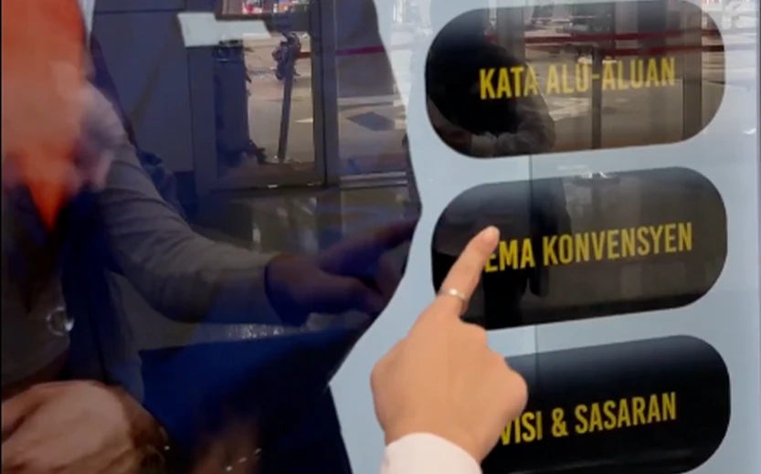 Officials interacting with holographic AI avatar