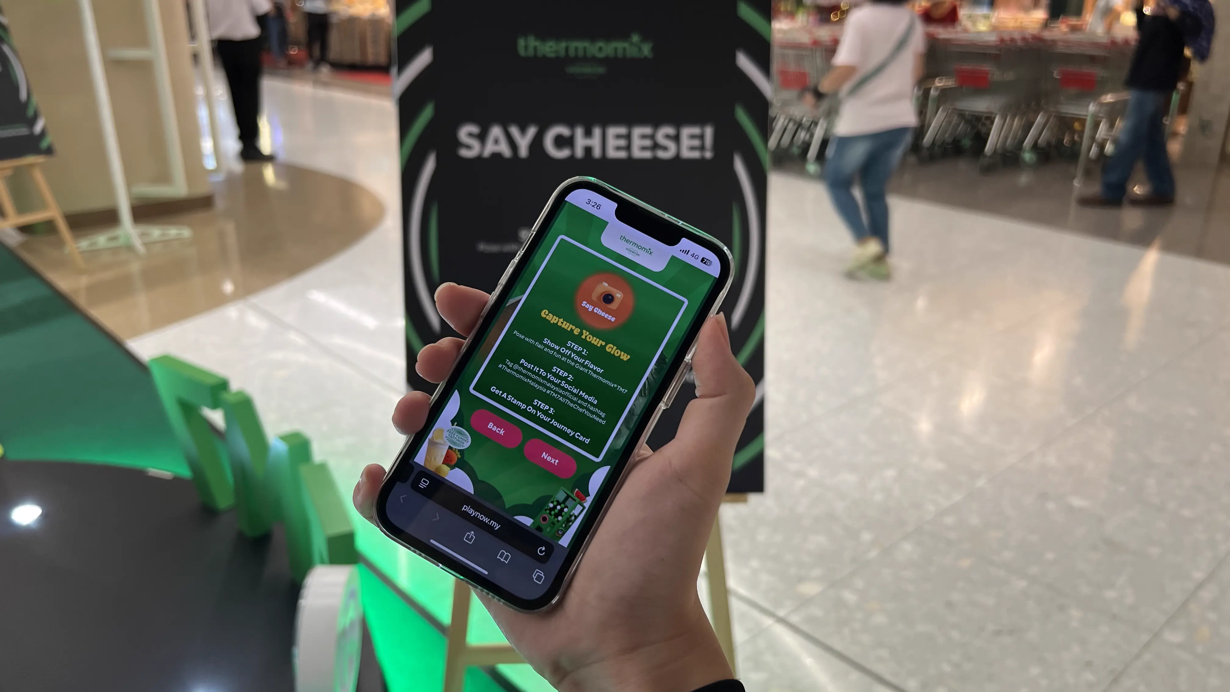 Guest at a branded activation station scanning a QR code on their phone