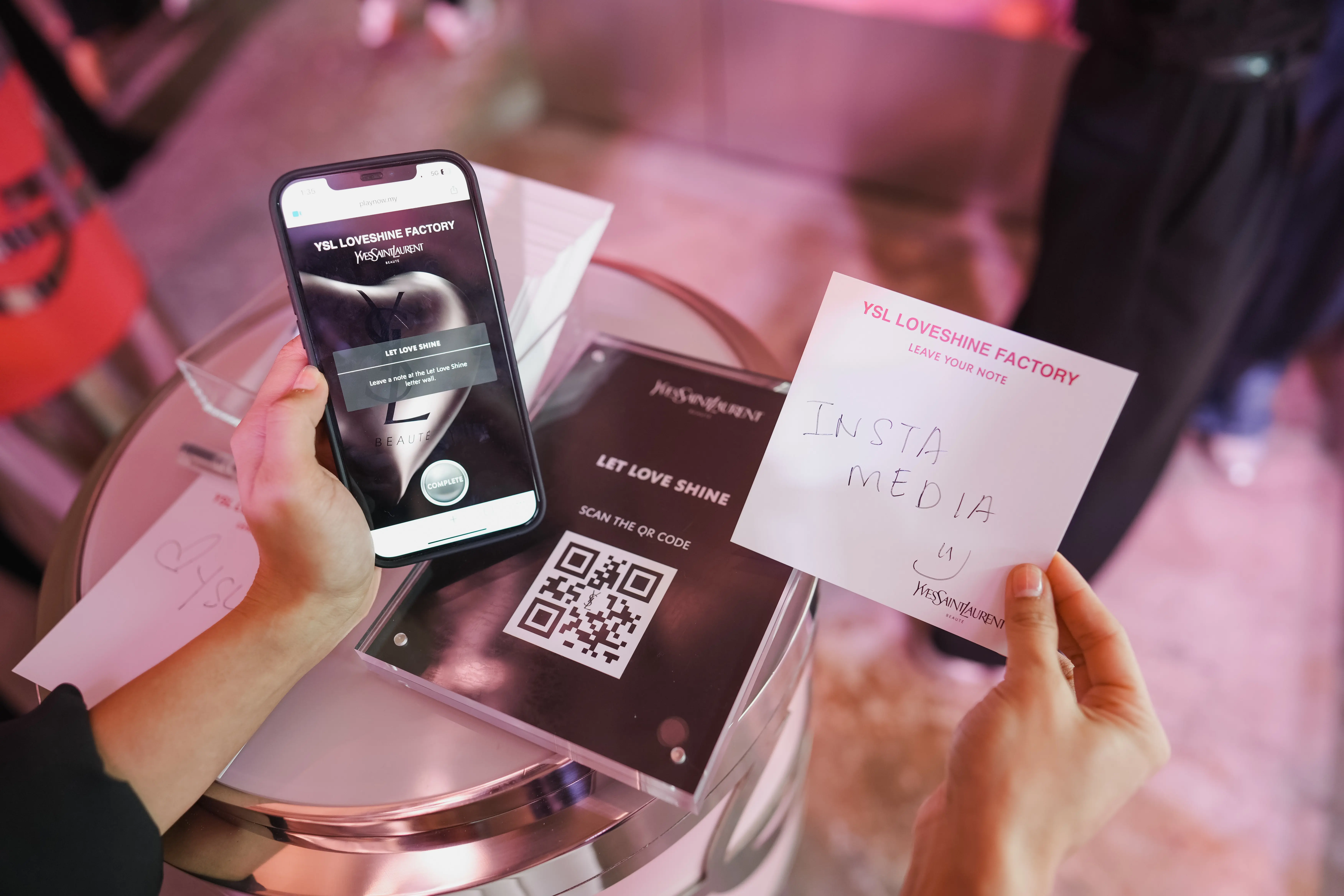 Guest holding a phone with the digital ESG passport open at an activation booth