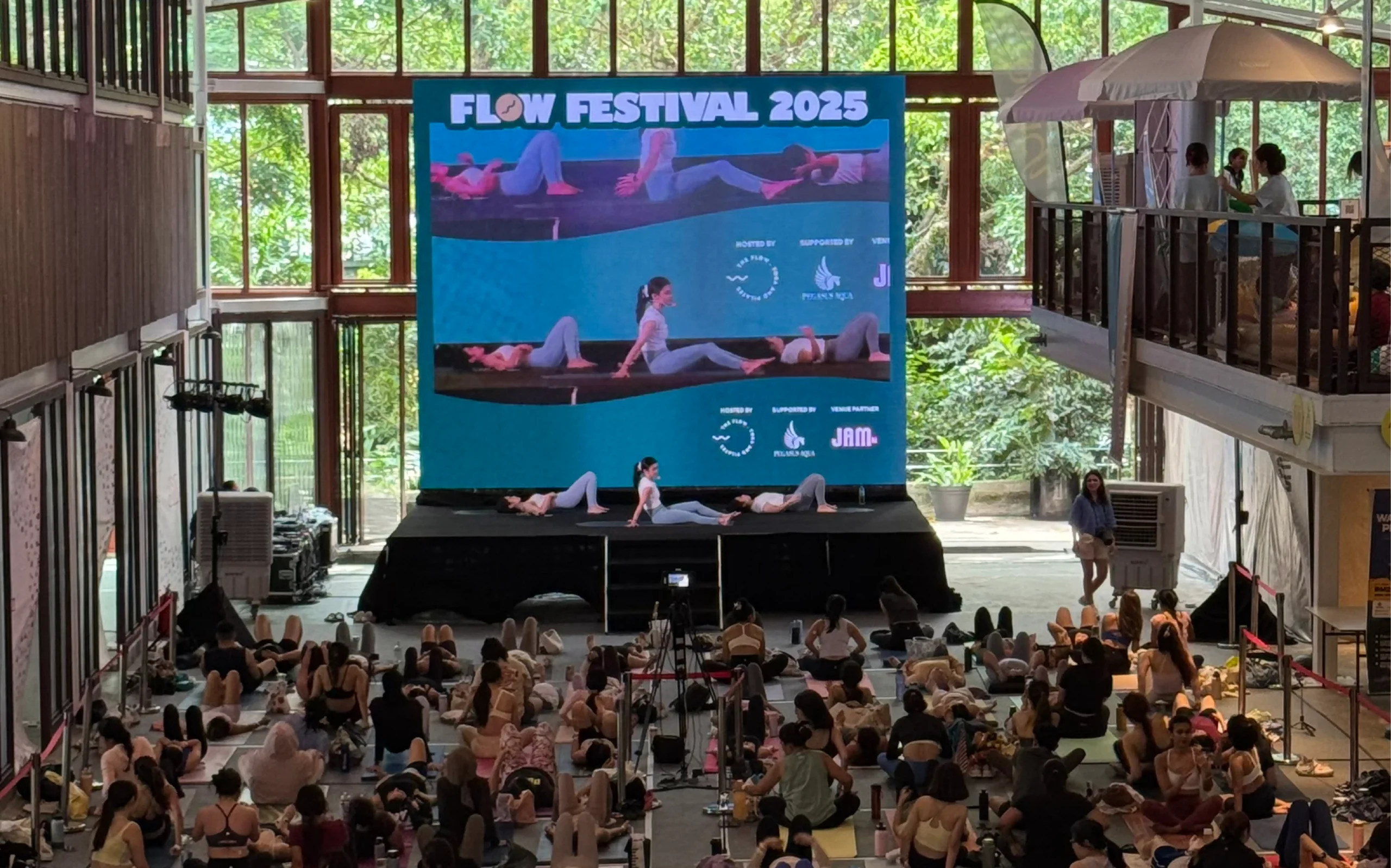 Flow Festival 2025 — live activation floor with a full crowd facing the LED screen, nothing printed in sight