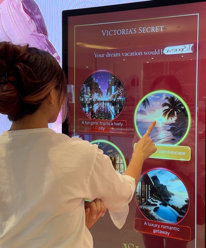 Guest answering a Victoria's Secret fragrance quiz question on the touchscreen kiosk at Pavilion KL